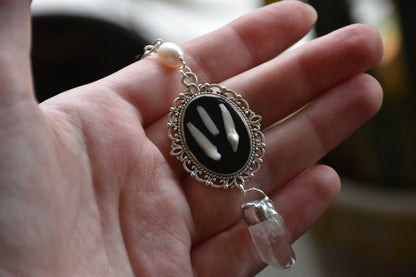 Black frame bone/tooth necklace clear quartz