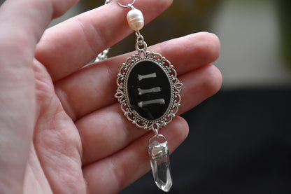 Black frame bone/tooth necklace clear quartz